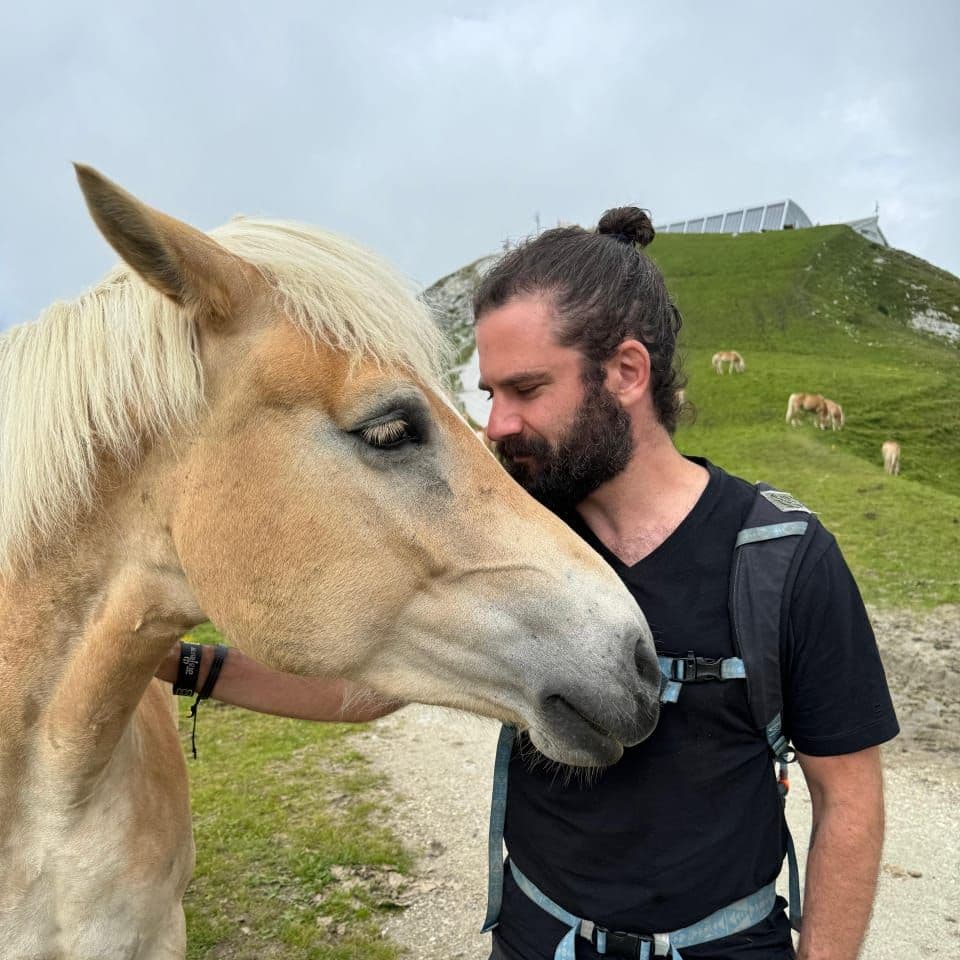 Matt with a horse on an alpine meadow
